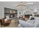 Open-concept living room with fireplace, sleek furniture, and an adjacent kitchen at 905 Battery Way, Mount Pleasant, SC 29464