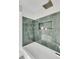 Stylish shower featuring green tile, a built-in niche, and a rainfall shower head at 905 Battery Way, Mount Pleasant, SC 29464