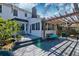 Inviting back deck with a wooden pergola, comfortable seating, and lush landscaping for outdoor enjoyment at 960 Mooring Dr, Charleston, SC 29412