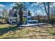 Backyard patio with seating, pergola, and large palm trees at 960 Mooring Dr, Charleston, SC 29412