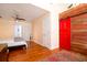 Spacious bedroom with hardwood floors, a red barn door, and a ceiling fan at 960 Mooring Dr, Charleston, SC 29412
