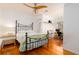 Bright bedroom features hardwood floors, ceiling fan, and a separate area for a desk at 960 Mooring Dr, Charleston, SC 29412