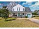 Well-maintained two-story home with a manicured lawn and a teal-colored front door and garage at 960 Mooring Dr, Charleston, SC 29412