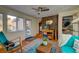 Relaxing sunroom with cozy seating, hardwood floors, brick accent wall and lots of natural light at 960 Mooring Dr, Charleston, SC 29412