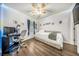 Cozy bedroom with a bed, desk, wood floor and natural light at 103 Old Tree Rd, Goose Creek, SC 29445