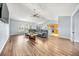 Spacious living room with hardwood floors, large windows, and an open layout to the kitchen at 103 Old Tree Rd, Goose Creek, SC 29445