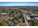 Aerial view of a residential area with lush trees, churches, and a glimpse of the nearby waterfront at 103 Tall Oak Ave, Charleston, SC 29407