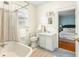 Bright bathroom showcasing vintage claw foot bathtub, with an entrance to a bedroom at 103 Tall Oak Ave, Charleston, SC 29407