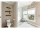 Bright bathroom featuring a glass shower, floating shelves and decorative chandelier at 103 Tall Oak Ave, Charleston, SC 29407