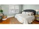 Cozy bedroom features natural lighting, hardwood floors, and a well-made queen-sized bed at 103 Tall Oak Ave, Charleston, SC 29407