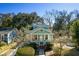 Charming two-story home featuring a welcoming front porch, complemented by lush landscaping at 103 Tall Oak Ave, Charleston, SC 29407