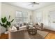 Inviting living room featuring hardwood floors, neutral furniture, and bright, natural light at 103 Tall Oak Ave, Charleston, SC 29407