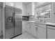 Modern kitchen with stainless steel refrigerator, white cabinets, and ample counter space at 105 Chadwick Dr, Charleston, SC 29407