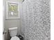 Bright bathroom featuring a toilet and shower with floral curtain at 105 Gatewood St, North Charleston, SC 29418