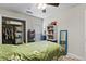 Light bedroom featuring a bed with floral bedding, a ceiling fan, and a white bookshelf at 105 Gatewood St, North Charleston, SC 29418