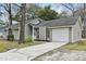 Charming home featuring a driveway and attached one car garage at 105 Gatewood St, North Charleston, SC 29418