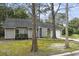 A single-story home with a driveway and a blend of trees in the front yard at 105 Gatewood St, North Charleston, SC 29418