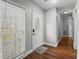 Hallway with wood floors leading to rooms; a bright window and a white front door on the left at 105 Gatewood St, North Charleston, SC 29418