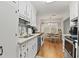 Modern kitchen featuring white cabinets, wood floors, and appliances; dining area in background at 105 Gatewood St, North Charleston, SC 29418