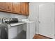 Laundry room featuring a stainless steel washer, white dryer and wooden cabinets at 105 Gatewood St, North Charleston, SC 29418