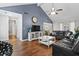 A spacious living room featuring wood floors, high ceilings, and a blue accent wall at 105 Gatewood St, North Charleston, SC 29418