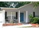Charming front porch with rocking chairs, attractive landscaping and a vibrant blue front door at 106 Equestrian Ct, Summerville, SC 29486