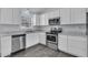 Modern kitchen featuring stainless steel appliances, white cabinets and gray countertops at 106 Equestrian Ct, Summerville, SC 29486