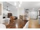 Bright dining room featuring a wooden table, hardwood floors and an open view to the living room and staircase at 112 Blue Heron Dr, Summerville, SC 29485