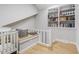 Hallway featuring hardwood floors, built in bookshelves and a crib at 112 Blue Heron Dr, Summerville, SC 29485