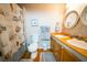 Bright bathroom features double sinks, wood cabinets, framed mirrors and seashell themed shower curtain at 1125 Rifle Range Rd, Mount Pleasant, SC 29464