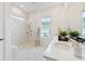 Bright bathroom featuring a tiled shower, vanity with sink, and a large mirror, creating a spa-like atmosphere at 1146 Darling St, Summerville, SC 29485