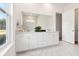 Bright bathroom features a large mirror above a double sink vanity and marble floors at 1146 Darling St, Summerville, SC 29485