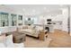 Bright, open-concept living room with hardwood floors, large windows, and seamless flow into the modern kitchen at 1146 Darling St, Summerville, SC 29485