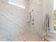 Elegant marble tiled shower with handheld shower head and natural light at 1146 Darling St, Summerville, SC 29485