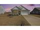 Charming home exterior with well-manicured lawn and inviting curb appeal at twilight at 1251 Wading Point Blvd, Huger, SC 29450