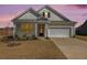 Charming single-story home boasting a well-manicured lawn, inviting entrance, and an attached two-car garage at 1251 Wading Point Blvd, Huger, SC 29450