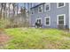 Spacious backyard featuring a well-maintained lawn and an outdoor patio area with seating and a grill at 127 Rosefield Ct, Summerville, SC 29485