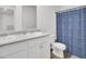 Well-lit bathroom features a double vanity, a toilet, and a shower with a blue patterned curtain at 127 Rosefield Ct, Summerville, SC 29485