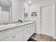 Bathroom with double sinks, white cabinets and gray countertops, featuring wood-look flooring at 127 Rosefield Ct, Summerville, SC 29485