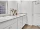Bright bathroom featuring double sinks, white cabinets, gray countertops and a modern shower curtain at 127 Rosefield Ct, Summerville, SC 29485