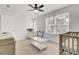 Cozy Bedroom featuring a comfortable chair, a crib, and a bright window overlooking the neighborhood at 127 Rosefield Ct, Summerville, SC 29485