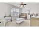 Bright bedroom featuring a ceiling fan, a crib, and plenty of natural light from the large window at 127 Rosefield Ct, Summerville, SC 29485