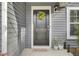 Inviting front door with a wreath, plants, and neutral welcome mat at 127 Rosefield Ct, Summerville, SC 29485