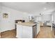 Open-concept kitchen featuring an island with a stainless steel dishwasher, sink, and neutral countertops at 127 Rosefield Ct, Summerville, SC 29485