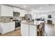 Bright kitchen with stainless steel appliances, island with seating, and view into the dining area at 127 Rosefield Ct, Summerville, SC 29485
