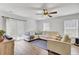Bright living room featuring a ceiling fan, sliding glass doors to patio, and comfortable seating at 127 Rosefield Ct, Summerville, SC 29485