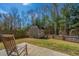 A spacious backyard featuring a storage shed and a wooden chair, all within a fenced perimeter at 1273 Discovery Dr, Ladson, SC 29456