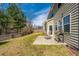 A spacious backyard features a patio, wooden fence, green grass and mature trees, perfect for outdoor enjoyment at 1273 Discovery Dr, Ladson, SC 29456