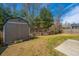 Backyard featuring a shed, green grass, partial fence, and small patio area at 1273 Discovery Dr, Ladson, SC 29456