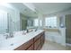 Bright bathroom featuring double sink vanity, large mirror, soaking tub and separate shower at 1273 Discovery Dr, Ladson, SC 29456